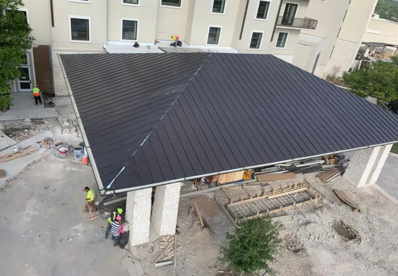 Metal roofing installation team working on a commercial building in Upper Darby